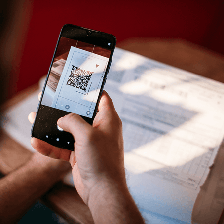 Man scanning QR code with smartphone Man scanning QR code with smartphone