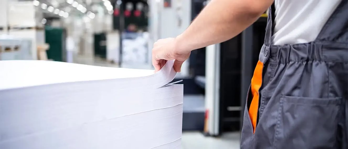 Man flipping through printer paper