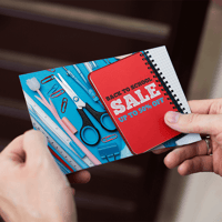 Hands holding a direct mail sales piece