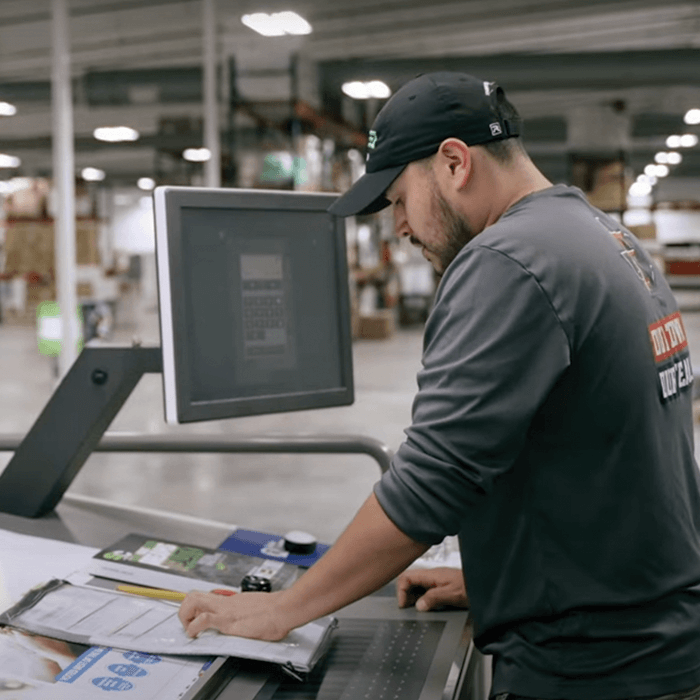 Slate Group print operator working at a print press